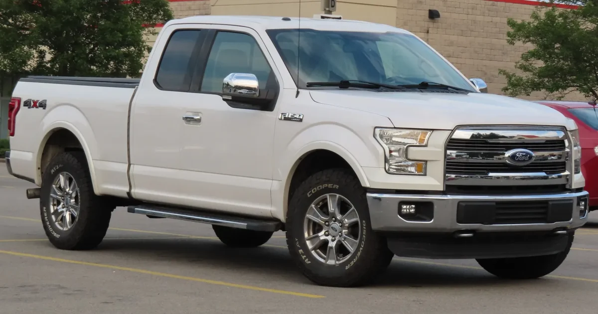 A white 2015 Ford F-150 Lariat SuperCab pickup in a parking lot