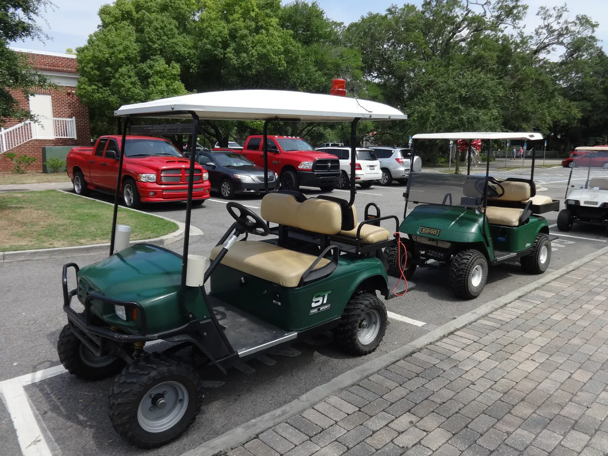 Two golf carts parked in a parking lot on St. Simons Island, Georgia