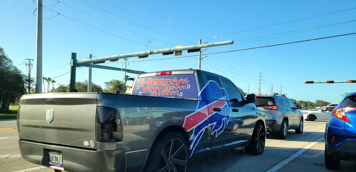 A grey Ram 1500 pickup with Buffalo Bills graphics wrapped on its side