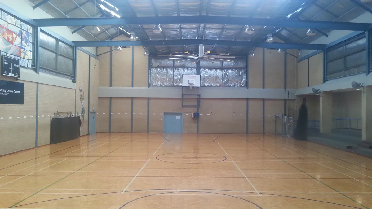 An indoor basketball court at a community recreation centre