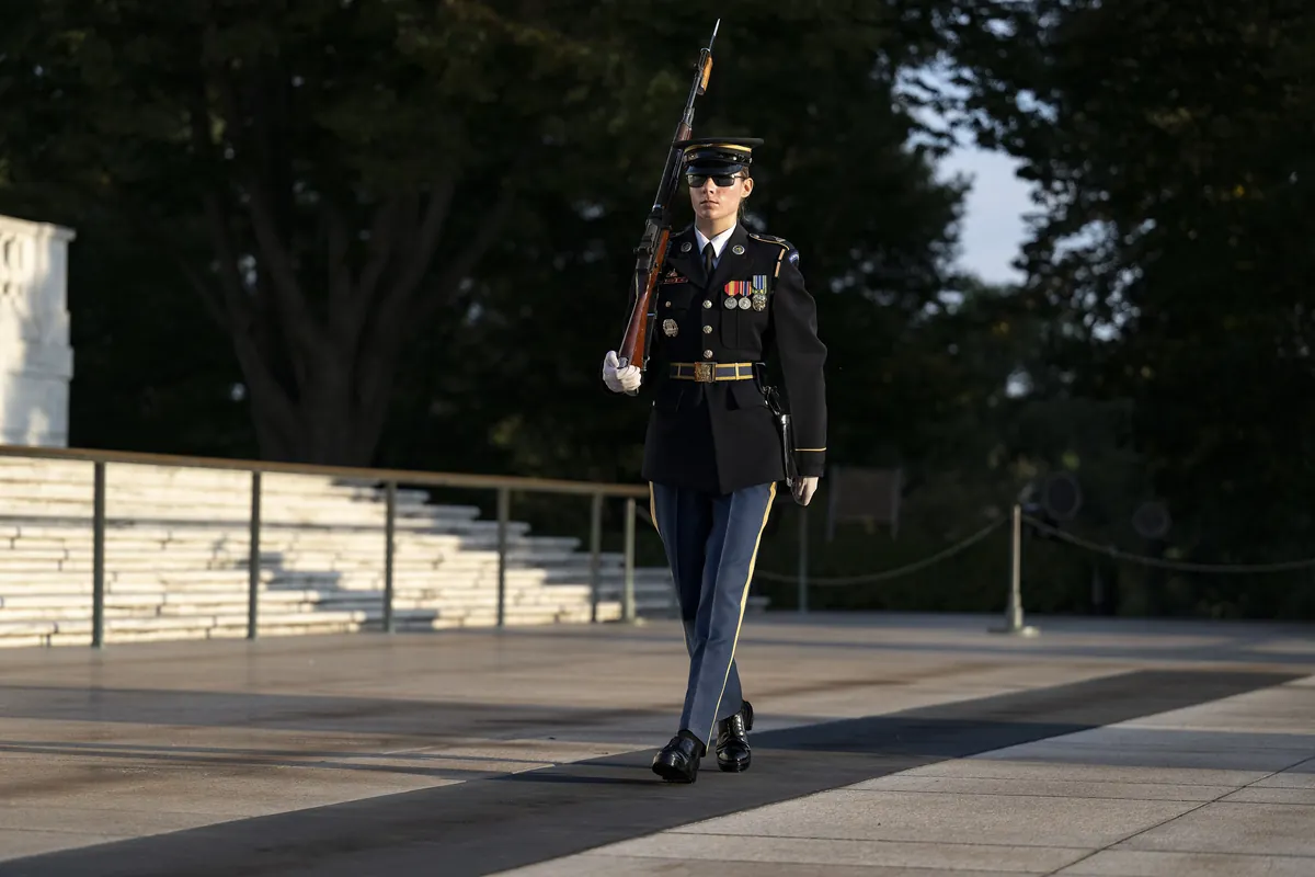 A Tomb Guard with a rifle walking the mat at the Tomb of the Unknown Soldier