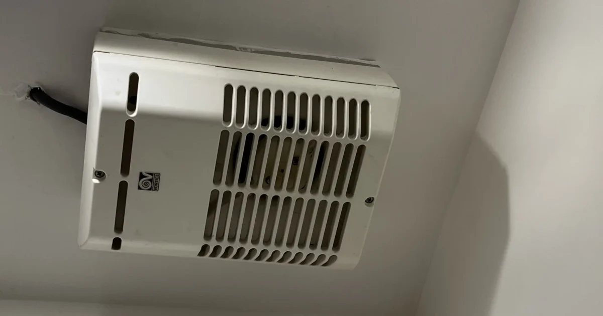 A white surface-mounted bathroom ventilation fan.
