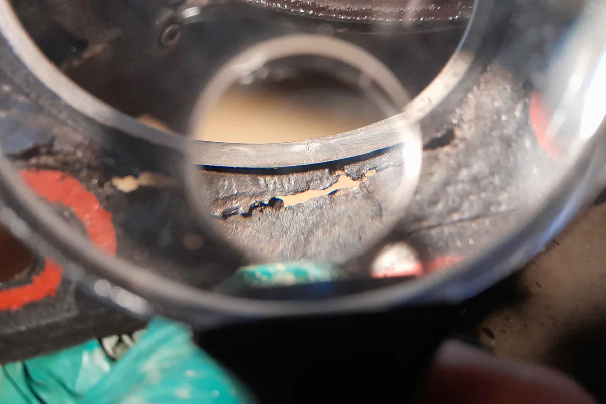 Magnified damage at a cylinder opening in a removed head gasket.