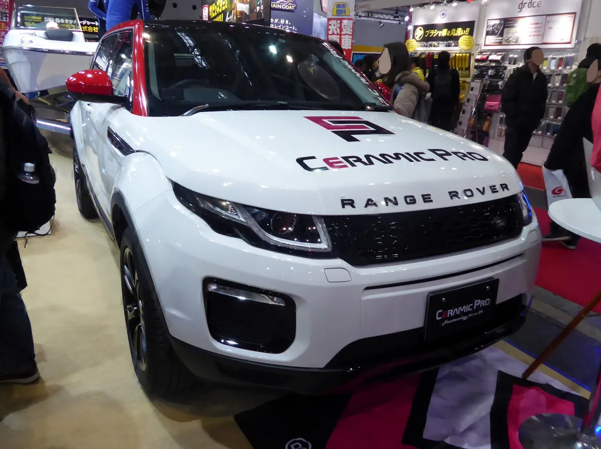 A white Range Rover Evoque coated by Ceramic Pro on a stand at a car show