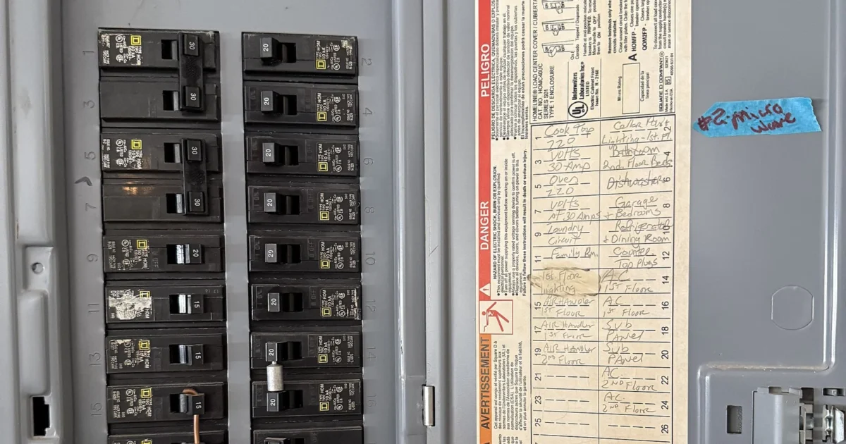 Rows of breakers and the circuit directory in a residential electrical panel.
