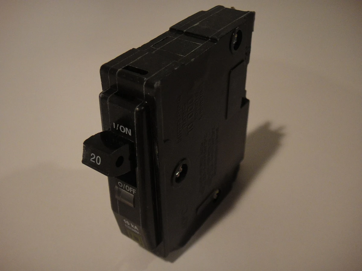 A Square D 20-amp single-pole circuit breaker photographed outside a panel.
