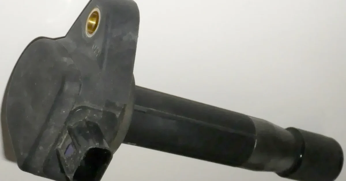 An individual ignition coil removed from a 2011 Honda Odyssey, shown horizontally.