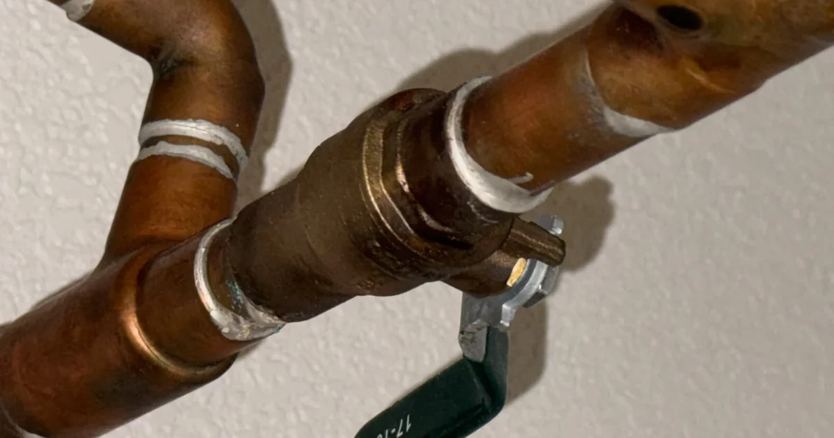 Copper water-supply pipes and a shutoff valve.
