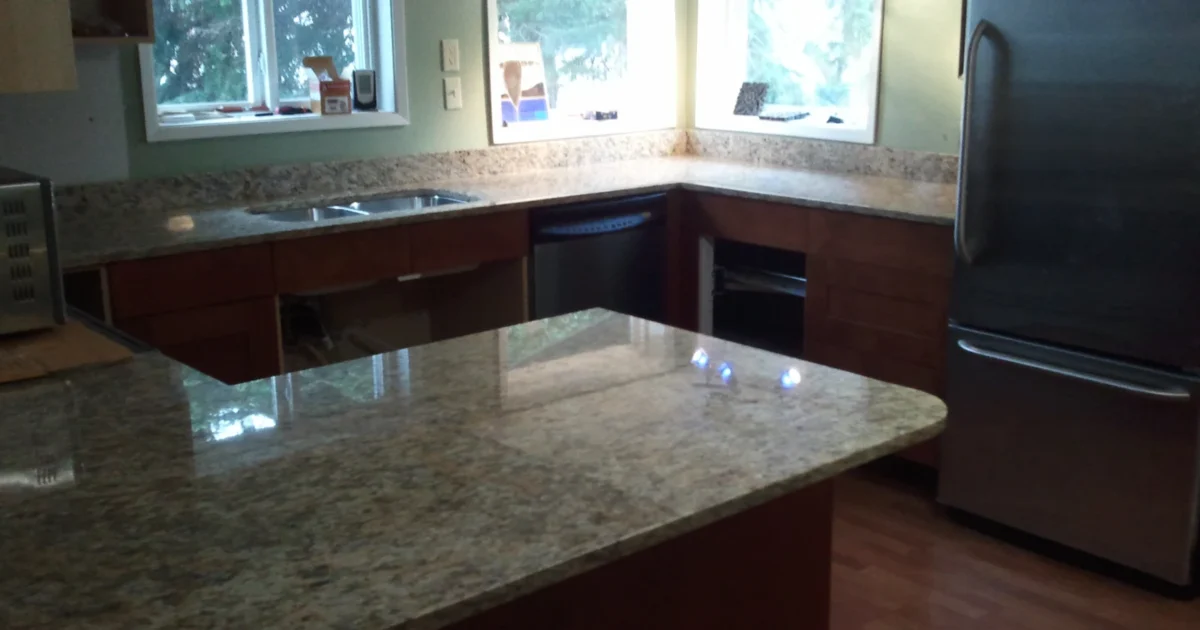 Kitchen with installed stone countertops and a peninsula.