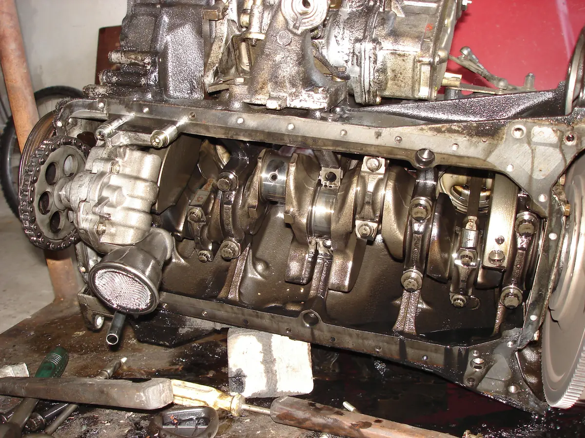 The underside of a diesel engine with the oil pan removed, showing the crankshaft and the connecting rods