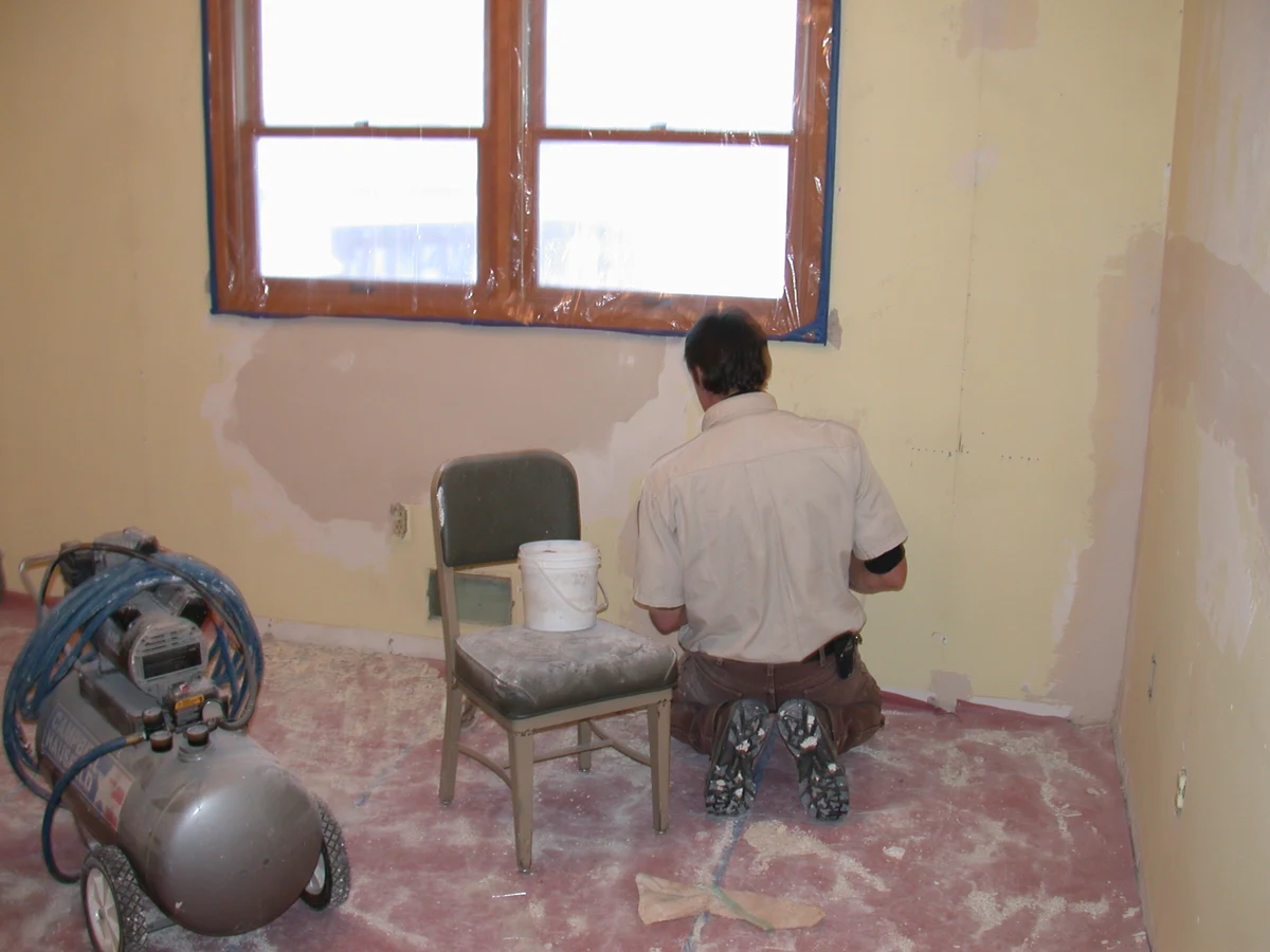 Drywall repairs around a window in hatchery staff quarters.