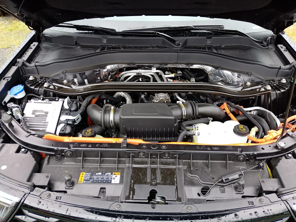 An open Ford Explorer engine bay showing the engine, intake and surrounding covers.
