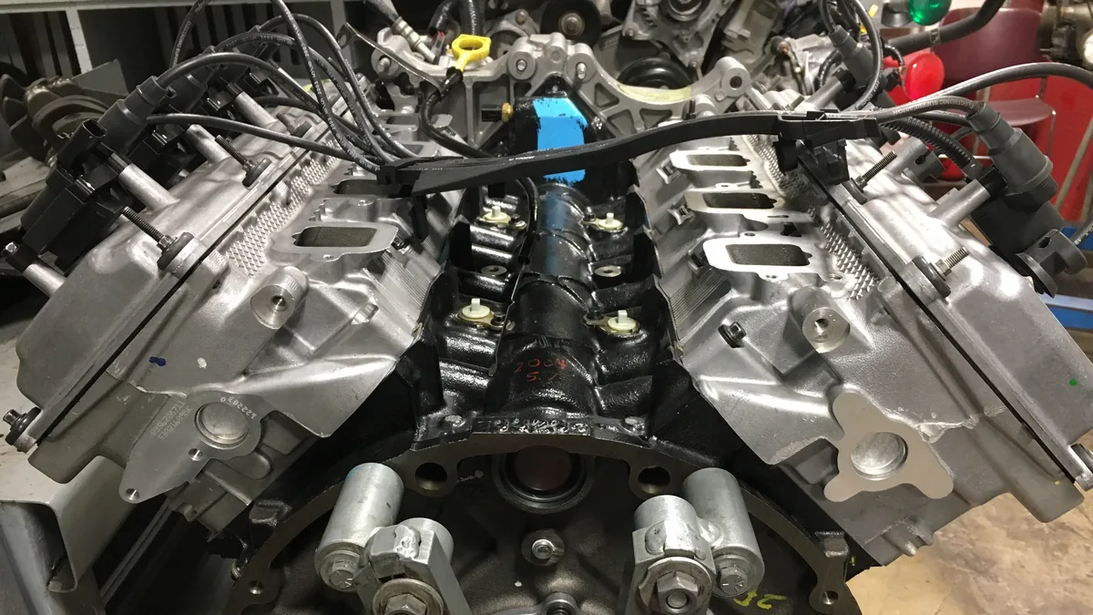 A Hemi V8 on an engine stand with its intake manifold removed, showing the square intake ports on both cylinder heads
