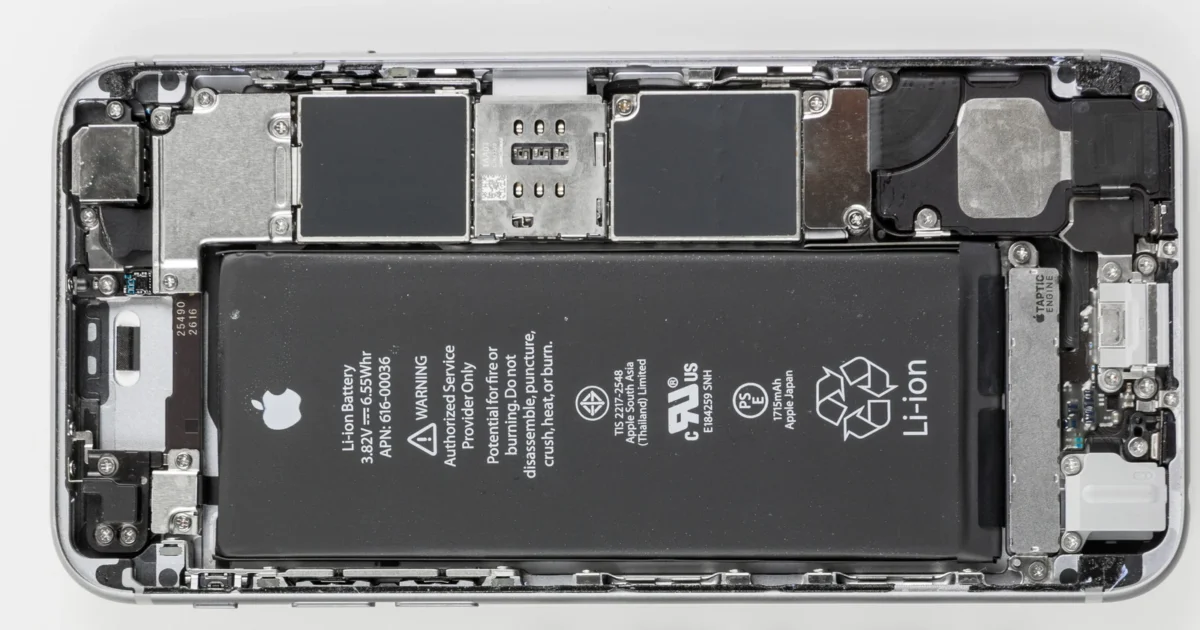 An opened iPhone 6s chassis with the battery and circuit boards visible, shown horizontally.