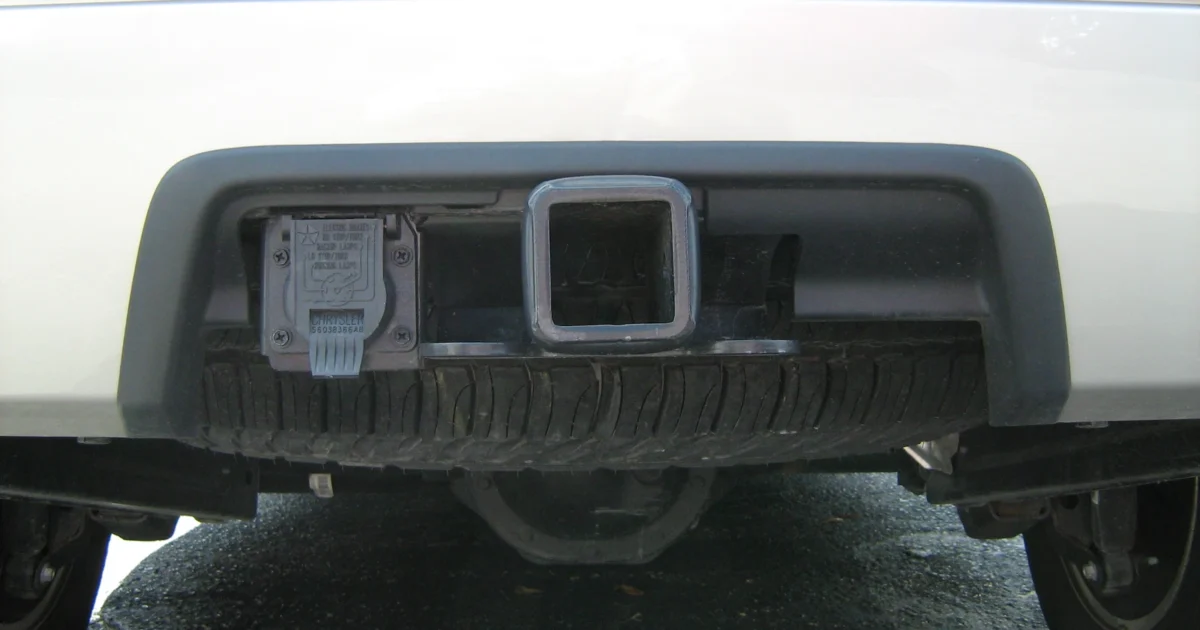 Square hitch receiver and trailer electrical socket at the rear of a 2008 Jeep Grand Cherokee.