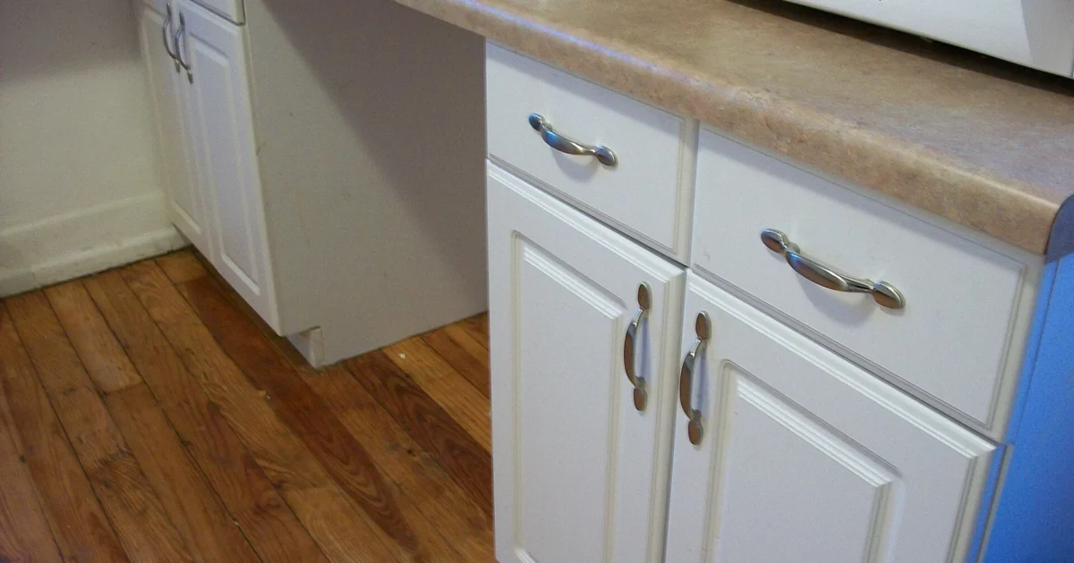 White base cabinets with drawers and doors under a kitchen counter.