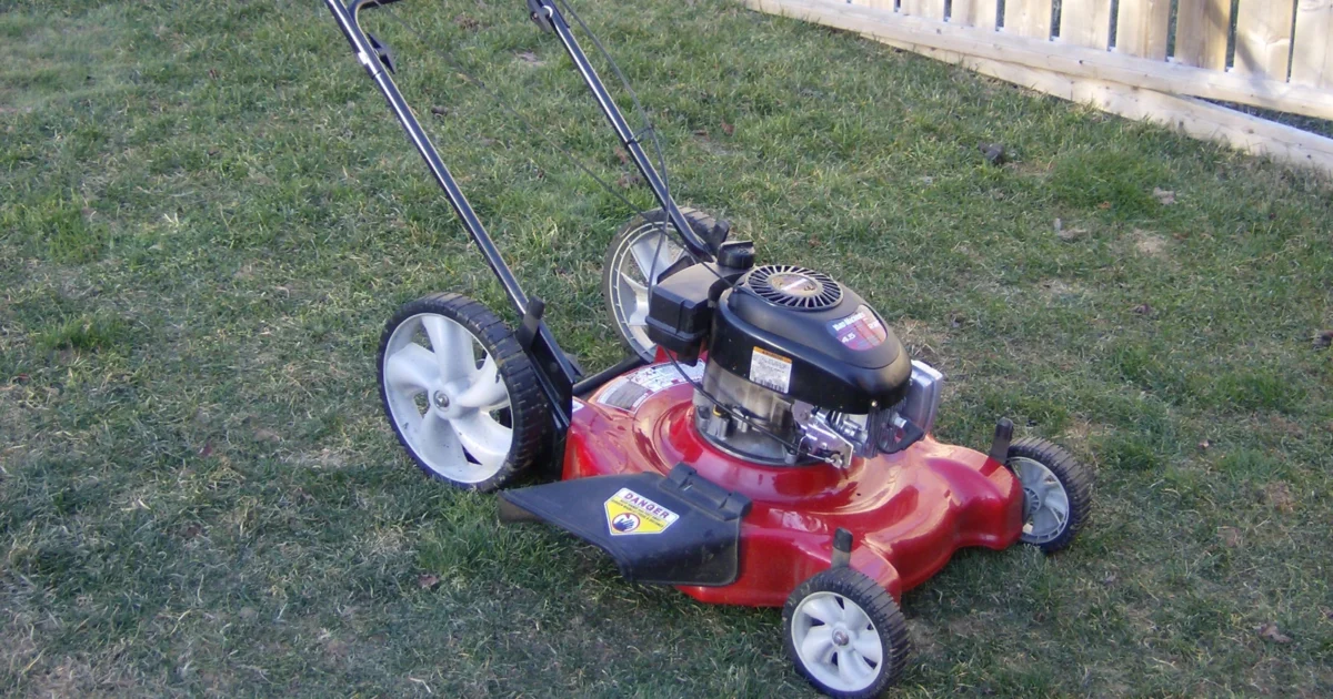 A red MTD Yard Machines gas mower with its engine above the cutting deck.