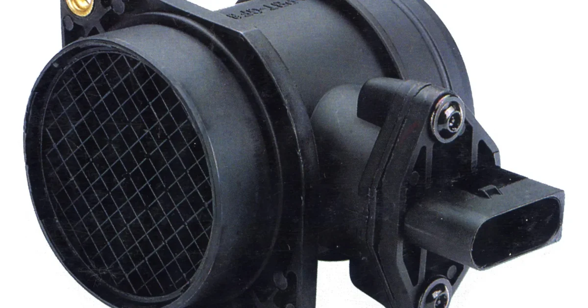 A black mass air flow sensor with a round mesh opening on the left and an electrical plug on its side