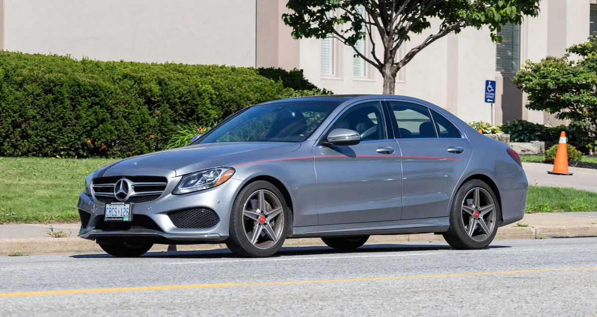A silver 2016 Mercedes-Benz C-Class sedan parked by a road