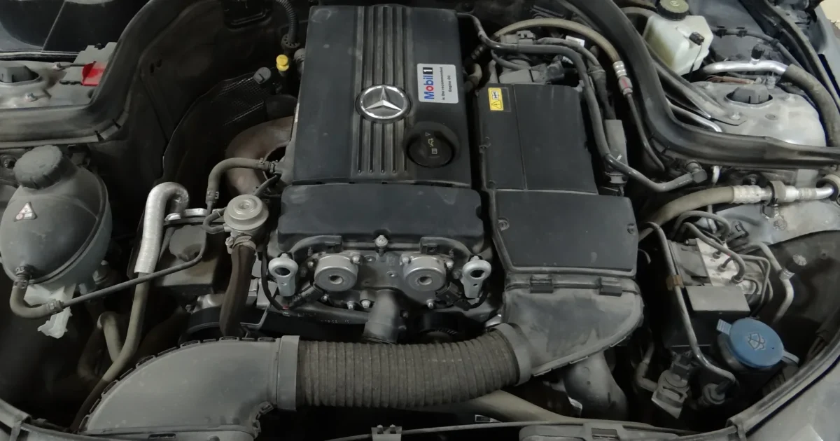 The engine bay of a Mercedes-Benz, with the oil filler cap on top of the engine