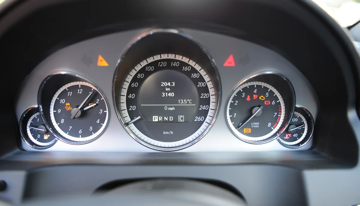 The instrument cluster of a Mercedes-Benz E 250, with a display between the dials