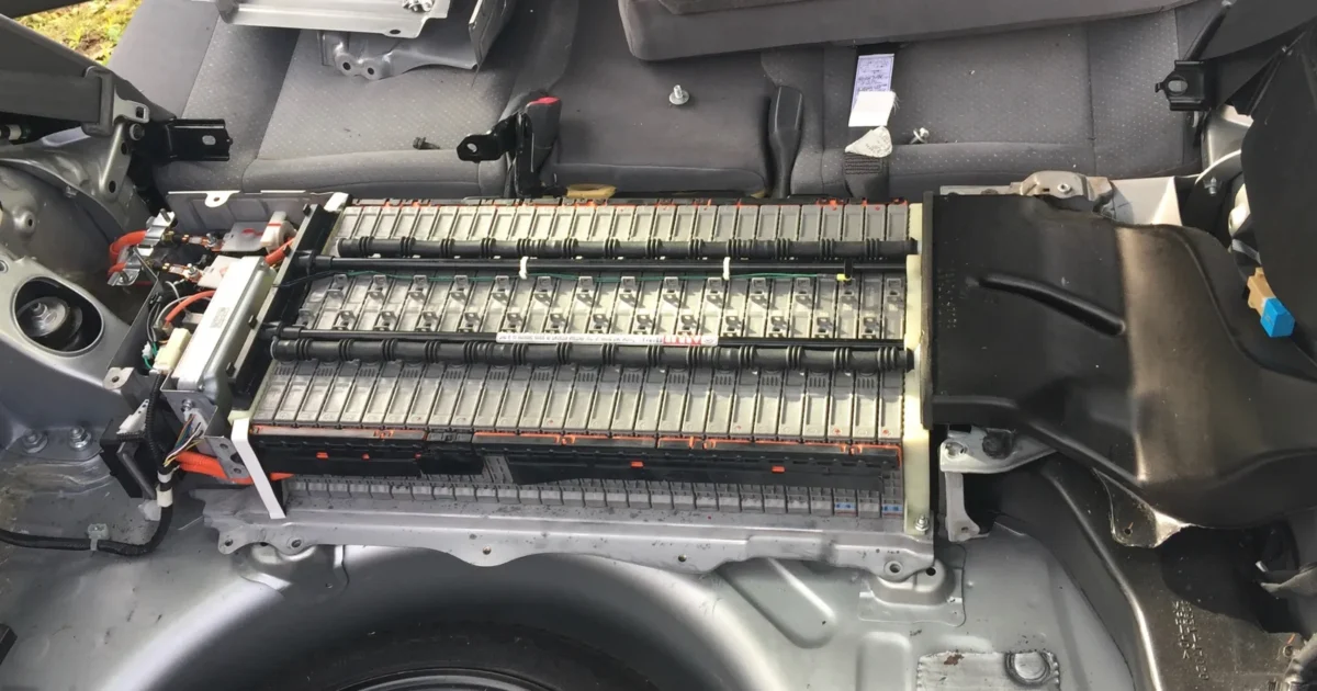 The hybrid battery of a 2005 Toyota Prius with its cover off, behind the back seat