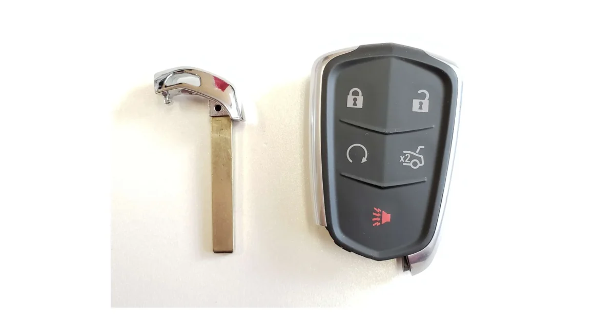 A car key fob with a circular remote-start symbol beside its emergency key blade.