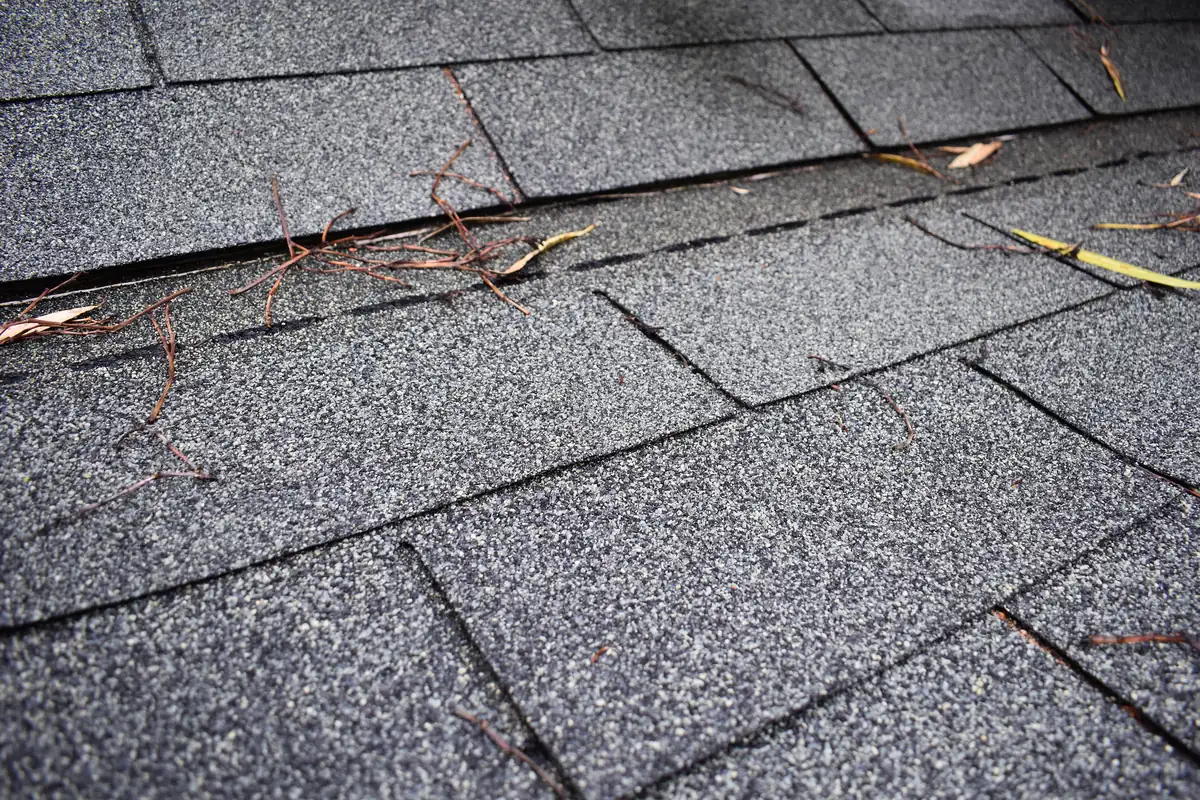 Overlapping courses of asphalt roof shingles.