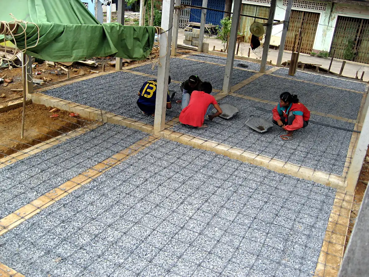 Workers tying steel reinforcement for a floor slab in Thailand.
