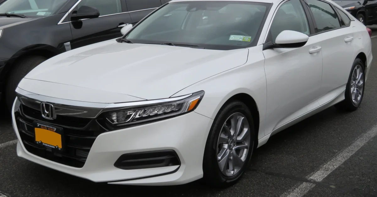 Front three-quarter view of a white 2018 Honda Accord parked in Queens, New York.