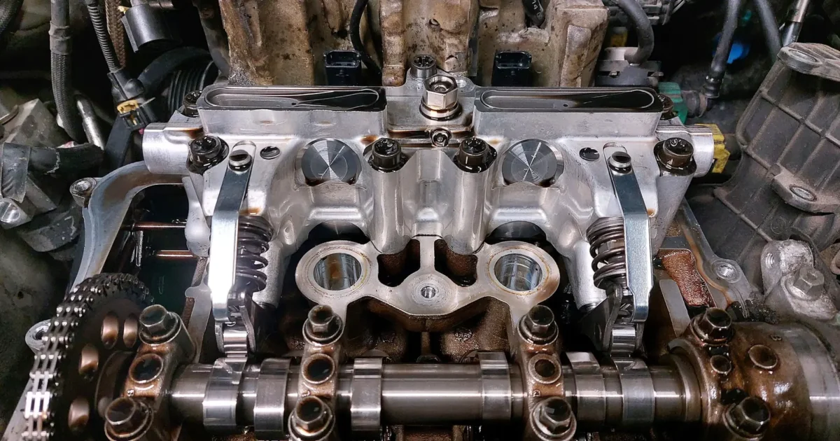 An open cylinder head showing the camshafts, the valve gear and the timing chain at one end