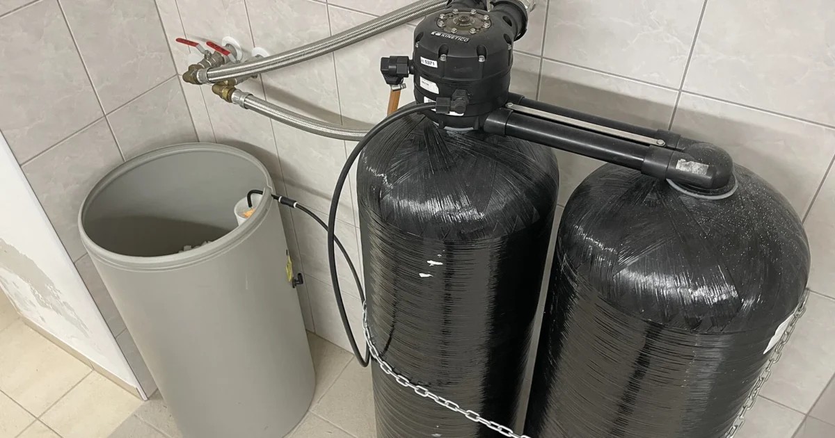 Water-treatment tanks beside an open salt container.